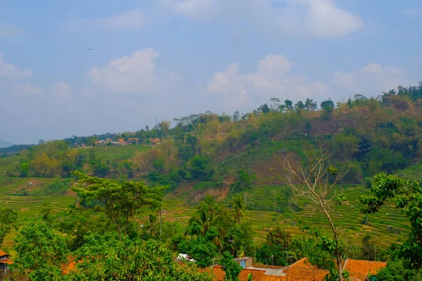 Landscape Photography. Landscape View. Scenic Nature Green and fertile hillsides. Beautiful hill landscape with blue sky background. Bandung, Indonesia