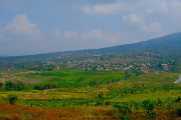 Landscape Photography. Landscape View. Scenic Nature Green and fertile hillsides. Beautiful hill landscape with blue sky background. Bandung, Indonesia
