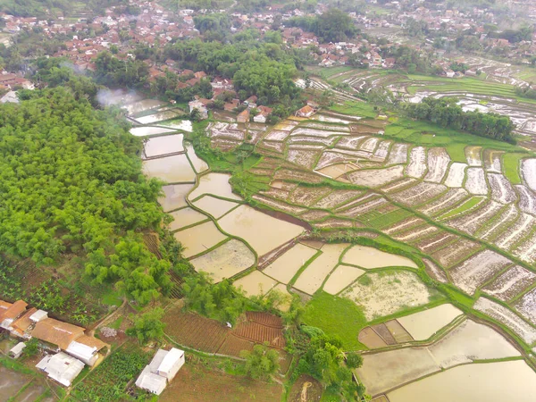 Indonesian Patchwork Landscape. Aerial Photography. Aerial panorama over green rice field. Shot from a drone flying 200 meters high. Cikancung, Indonesia