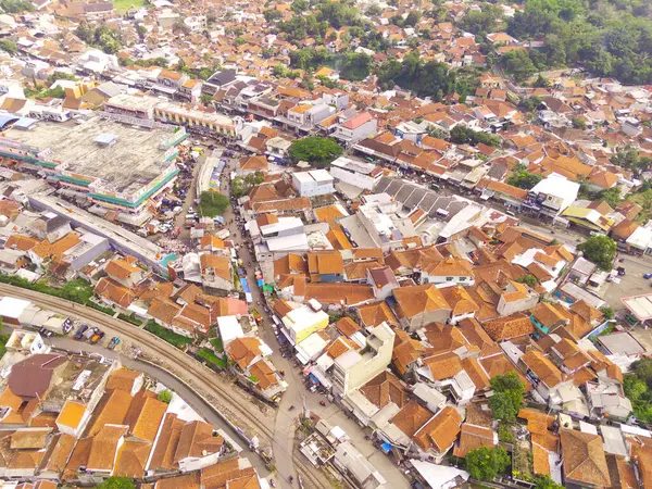 Top view or aerial shot Train Tracks intersection. Bird\'s eye view from drone of a railway crossing the Cicalengka highway, Indonesia. Shot from a drone flying 200 meters high.
