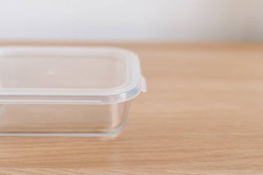 Ahşap yüzeyinde plastik kapaklı cam kap, gıda ürünlerinin depolanması ve korunması