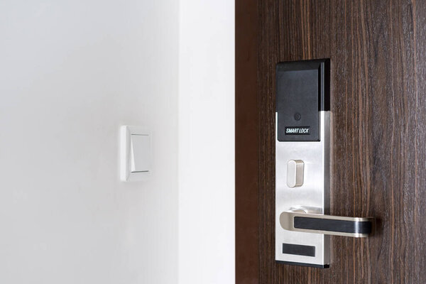 smart card door key lock system on door of hotel room, keyless and contactless lock, wireless technology 