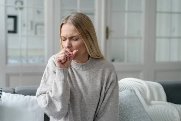 blonde upset woman with disease symptoms, fever and influenza, illness girl alone at home, has bronchitis and feeling weakness