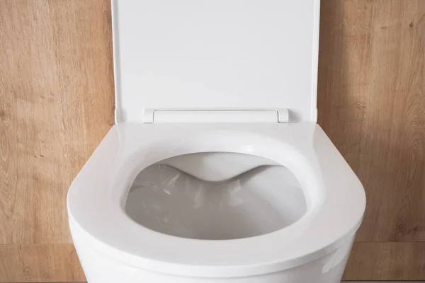 Closeup New Clean Ceramic Toilet Bowl Open Plastic Lid Contemporary — Stock Photo, Image