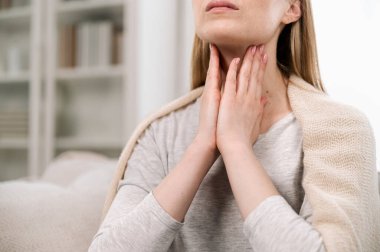 Cropped view of woman hands touching lymph nodes on throat. Self-examination and palpation thyroid glands. Having pain or scratchy sensation clipart