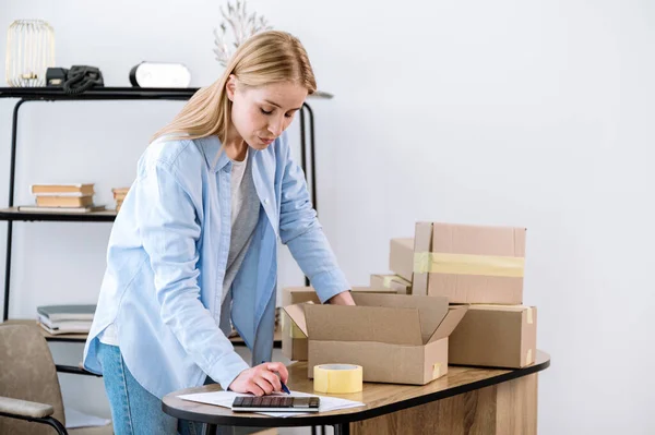 Female Entrepreneur Checking Online Orders Packing Products Boxes Small Warehouse — Stock Photo, Image