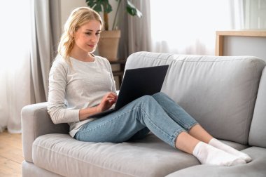 Rahat koltukta oturan, evinde dizüstü bilgisayar kullanan, sosyal ağda arkadaşlarıyla sohbet eden gülümseyen bir kadın. Kadın hafta sonunu film izleyerek, internetten alışveriş yaparak, modern bilgisayarında e-posta yazarak geçiriyor.