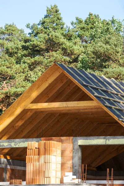 stock image Attic renovation. Example of new family house under construction. Vertical shot of wooden roof with energy efficient isolation coating. Rooftop covered with protection membrane and waterproof layers