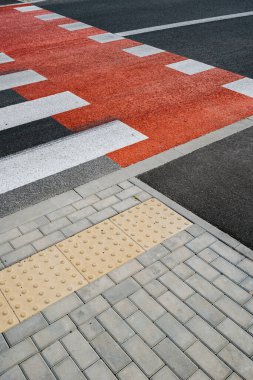 Yaya geçidinde yüksek açı, gri asfalt üzerinde yeni beyaz çizgiler ve şehir caddesinde bisiklet yolu. Karşıya geçmek için bir yer. İşaretli yolu olan kaldırım ve yaya geçidi