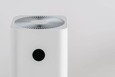 Beyaz arka planda elektronik hava temizleyicisi. Hepa filtresiyle nemlendirici. Ev aletleri, alerji, virüs ve toz kirliliğinden arındırılmış. Sağlık için modern teknolojiler.