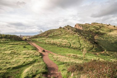Edinburgh and Arthurs Seat in a beautiful day, Scotland, United Kingdom. Hills and mountains with path.