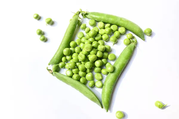 stock image Fresh green pea on white background. There is a lot of vitamins  and Minerals in it. Thepeais most commonly the small sphericalseedor the seed. Popular vegetable of all over world. 