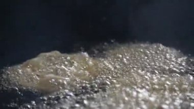 Jalebi yapımı. Hindistan 'ın alt kıtasında popüler bir atıştırmalık. Birçok isim var; jilebi, jilipi, zulbia, mushabak, zlabia ve zalabia. Maida un hamuru ve şeker şurubu tarafından yapılıyor. Yavaş çekim videosu. 