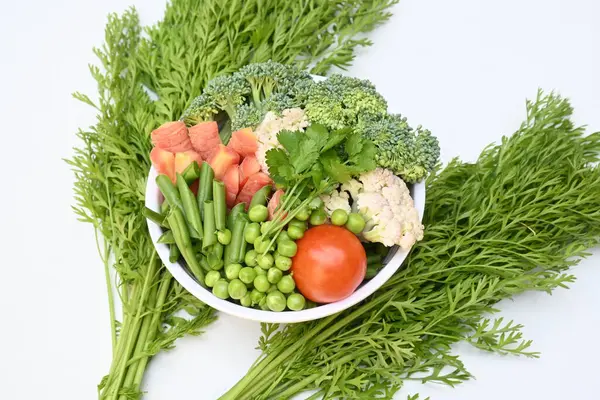 Canlı taze sebze karışımı. İçinde brokoli, karnabahar, domates, havuç, yeşil fasulye ve bezelye var. Bahar mevsiminin renkli sebzeleri, sağlık için iyidir. Renkli ekran.