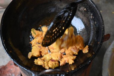 Demir kalemle kızartılmış soğan pakora. Bu Hint alt kıtasında popüler bir sokak yemeği. Mevsimlik baharatlı gram un hamuruyla kaplanmış ve bol yağda kızartılmış soğan. Hindistan kökenli..