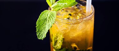 passion fruit mojito, rum drink, passion fruit, with mint, summer drink served chilled, isolated black background