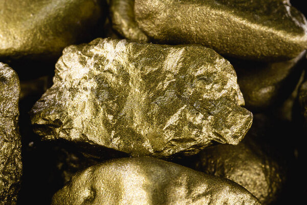 gold texture, many gold nugget, stone of value. Crude gold drawn on black background. Concept of wealth or luxury.