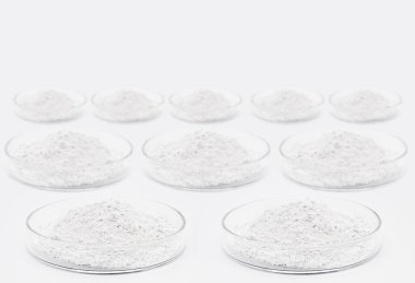 İzole edilmiş beyaz zemin üzerinde çeşitli kimyasallar, fosfat, çinko, polisiyanat, resveratrol, selüloz, betulin ve diğer ilaçlarla dolu petri kapları