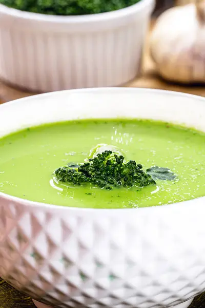 homemade soup of green vegetables, pea and broccoli, diet vegan soup served hot