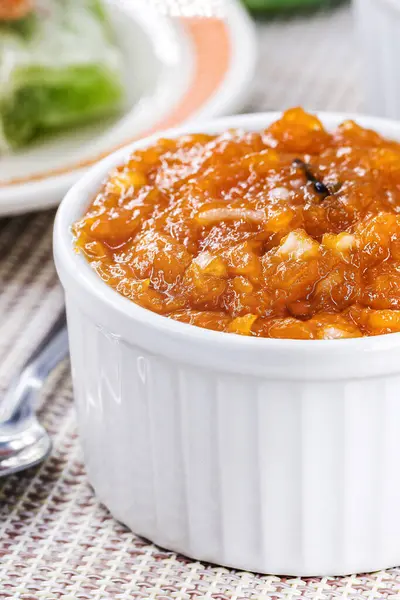 Brazilian pumpkin jam or pudding, with candied pumpkin jam in the background, tradition of the Brazilian June festivals
