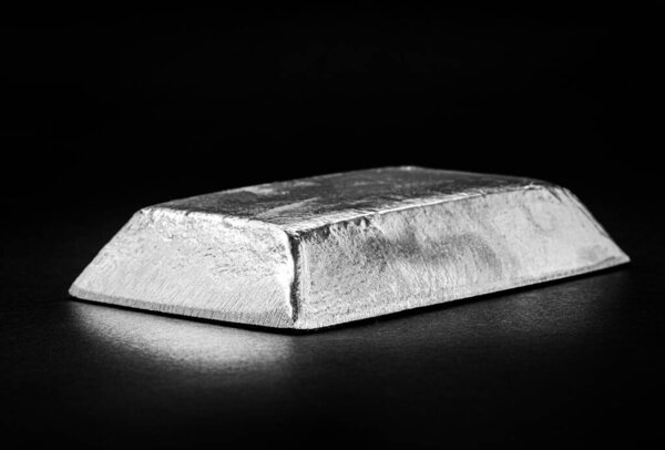 ingot or zinc bar isolated on insulated black background, metal used in the production of alloys or the galvanizing of steel structures