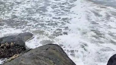 Padang City, Batı Sumatra, Endonezya 'nın batı kıyısındaki sahil dalgaları büyük doğal kayalardan oluşan dalgalara çarpıyor. Deniz kıyısının güzel manzarası. 