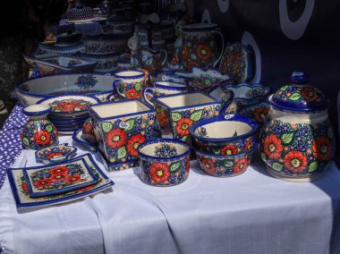 Boleslawiec, Poland - August 17, 2024: Traditional white and blue handmade polish pottery at the ceramics festival in old town market square. clipart