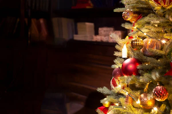 Decorated Christmas tree with lights in the interior. Holiday mood. Copy space. Selective focus, defocus