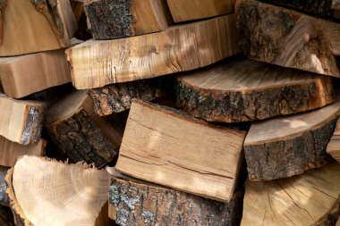 Prepared log of firewood for chopping. Preparing for the winter. Harvesting firewood. Natural resources. Heating without gas. Background of dry chopped firewood. Wooden background. Natural texture.