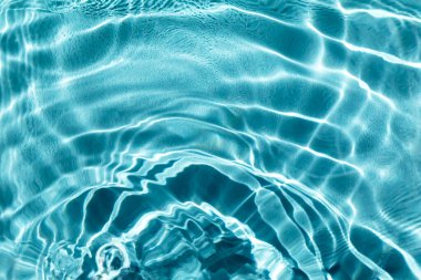 Waves on the water in the pool. Basin, river, ocean. Blue textured background for your design. Selective focus, defocus