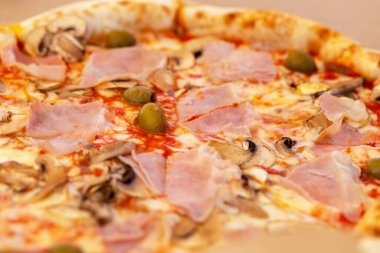 Pastırmalı, mantarlı ve zeytinli taze pizza. Seçmeli odak, ayrışma