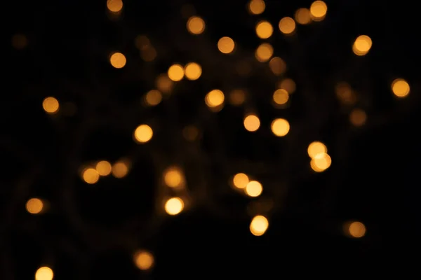 Abstract background of blurred yellow lights for design. Lights bokeh dis focus. Christmas background, copy space