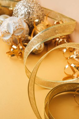 New Year and Christmas background. Christmas balls and tinsel on yellow background. Front view