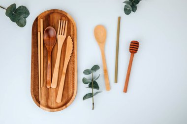 Set of wooden eco friendly devices. Zero waste concept. A cutlery, bamboo straw, on white background. Flat lay