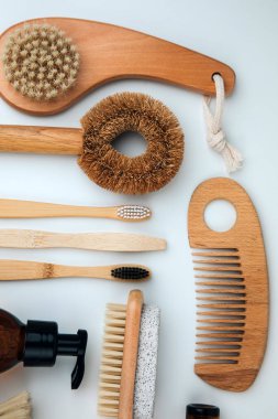 Set of wooden eco friendly devices. Brushes, washcloth and wooden comb, natural soap on a white background. Flat lay