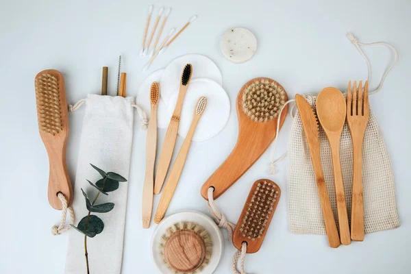 Set of wooden eco friendly devices. Brushes, washcloth and ear sticks, natural soap on a white background. Flat lay