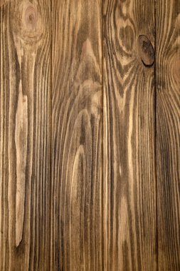 Brown textured wooden background, burnt wood. Background of yellow wooden boards for design