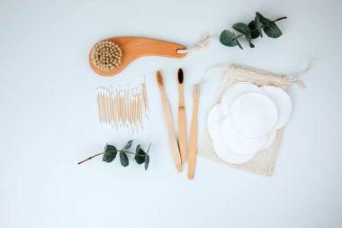 Set of wooden eco friendly devices. Brushes, washcloth and ear sticks on a white background. Flat lay