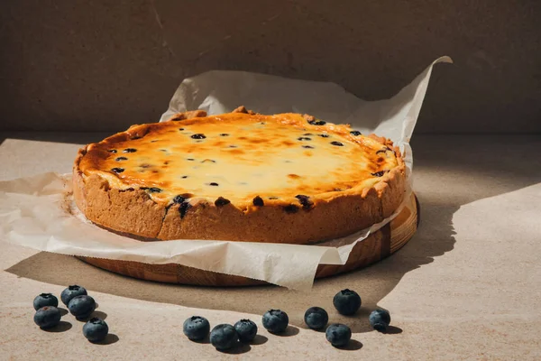 Ready cheesecake with blueberries in a baking dish in the oven. Front view