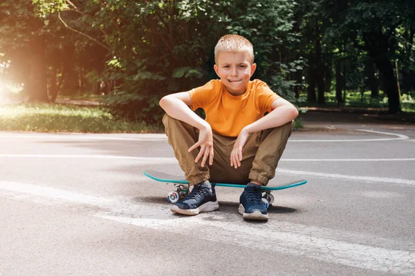 Outdoor Activities Children Cheerful Young Boy Bright Clothes Sits Skateboard — Stock Photo, Image