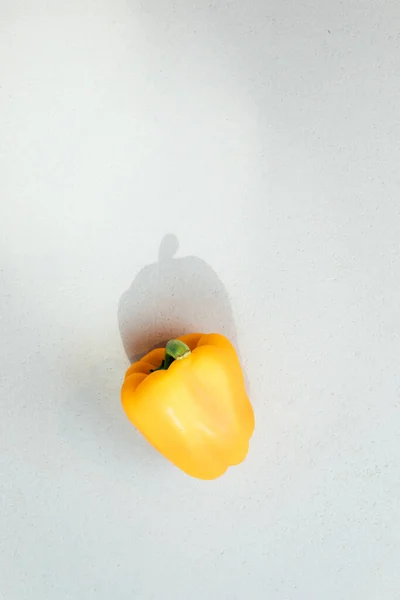Bell pepper on a concrete background. Garden background, bell pepper harvest. Ripened yellow paper. Top view