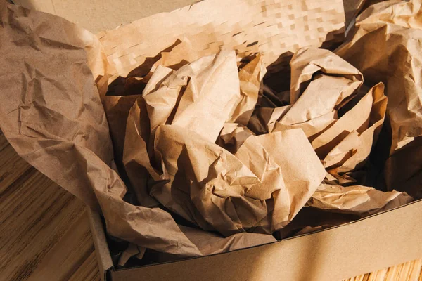 Ekolojik malzemelerin ambalajı. Işık arkaplan üzerinde karton kutu ve ambalaj kağıdı. Gezegeni tespit edilemeyen enkazlardan kurtarmak. Üst görünüm