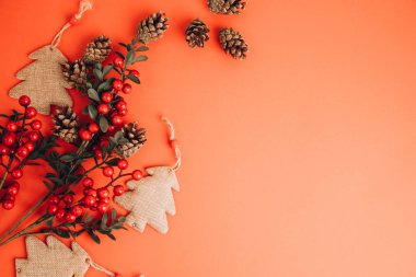 Noel arkaplanını boş alanla karşılamak. Kırmızı arka planda kahverengi Noel ağaçları. Üst görünüm