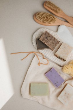 Doğal malzemelerden elde edilen el yapımı sabun, tekstil torbalı çeşitli otlar ve doğal bez. Sürdürülebilir kullanım kavramı, banyo ürünleri. Üst görünüm