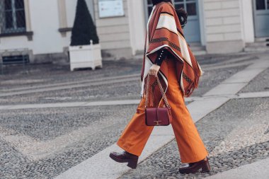 Milan, Italy - February 25, 2022: Street style, woman wearing fashionable outfit. clipart