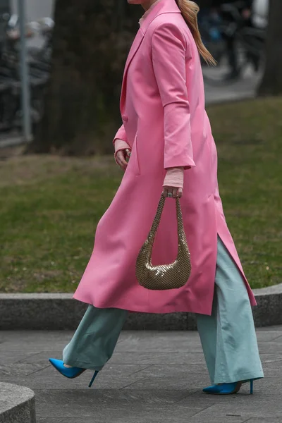 Crop stylish female with small handbag walking on street