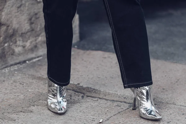 Stock image Milan, Italy - February 24, 2022: Woman wearing dark jeans and silver glitter pointy toe stiletto heeled boots.