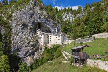 Editorial: PREDJAMA, SLOVENIA, SEPTEMBER 13, 2022 - Predjama castle with its cave seen from the village
