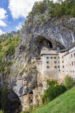 Approaching Predjama Castle from the village below