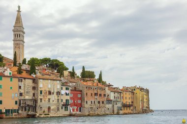 The old town of Rovinj with the Adriatic Sea in the background and with the Church of St. Euphemia rising high above the houses